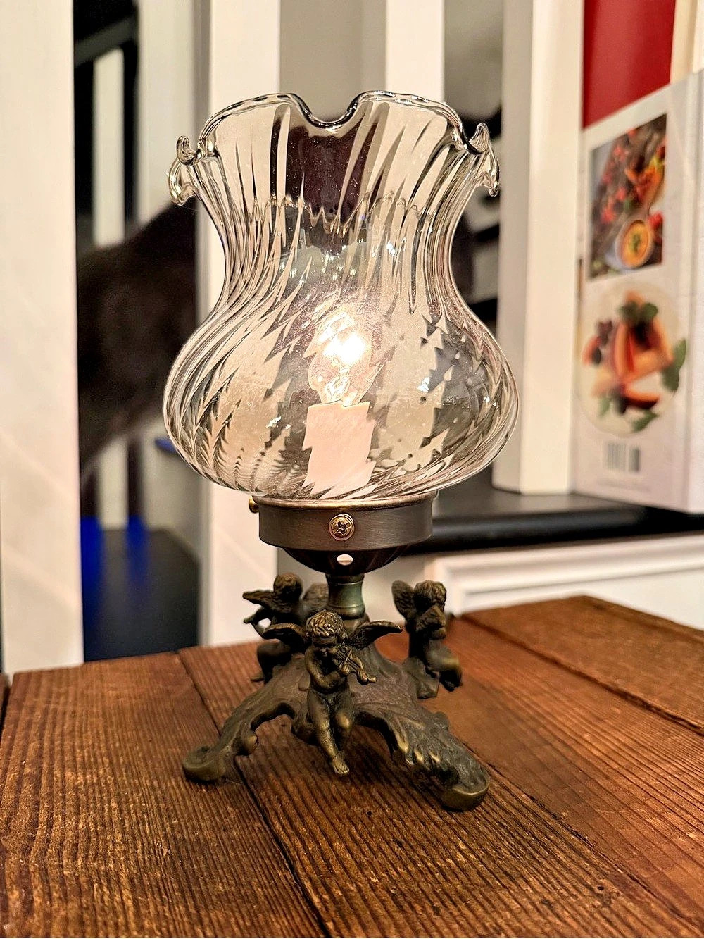 Vintage-style figural cherub boudoir table lamp with ruffled glass shade